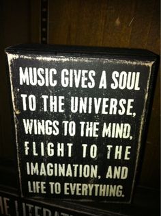 a sign that says music gives a soul to the universe, wings to the mind, flight to the imagination, and life to everything