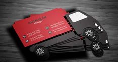 some business cards are stacked on top of each other, with black and red accents