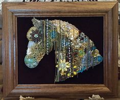 a wooden frame with a horse made out of jewelry