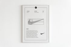 a white poster hanging on the wall next to a black and white photo with an image of a nike logo