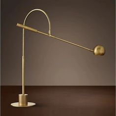 a gold colored lamp on a brown table