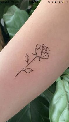 a single rose tattoo on the arm