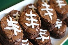 chocolate brownies with white frosting in a football shape