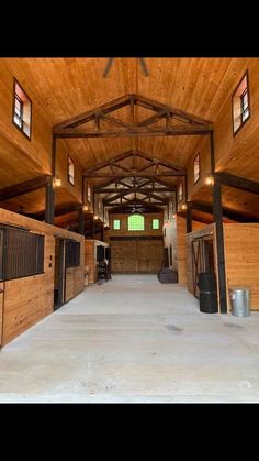 the inside of a horse barn with stalls and stalls