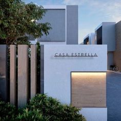 a white building with the word casa estrella on it's side and trees in front