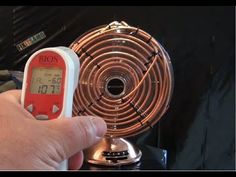 a person is checking the temperature on an electric fan