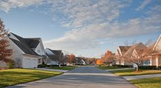 a residential street lined with houses and trees