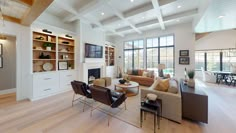 a living room filled with furniture and lots of windows