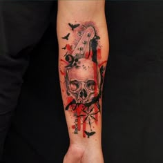 a person with a tattoo on their arm holding a cell phone and a skull in the middle