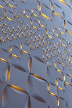 an abstract wall made up of circles and dots with light reflecting off the top surface