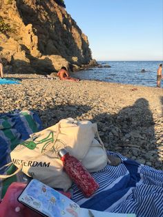 there is a bag and some books on the beach