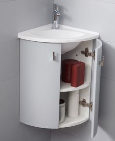 a white bathroom sink sitting under a mirror