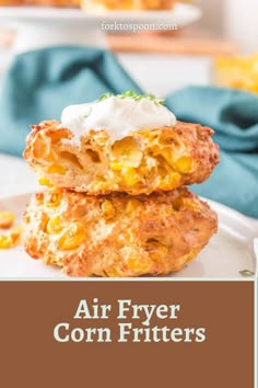 air fryer corn fritters are stacked on top of each other and topped with sour cream