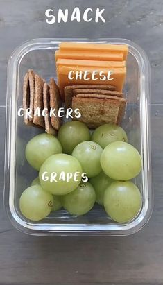 a plastic container filled with grapes and crackers