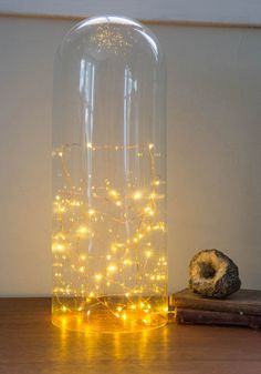 a glass vase with some lights in it