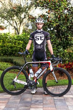 a man is standing next to his bike