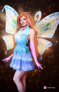 a woman dressed as a fairy standing in front of a star filled sky with stars