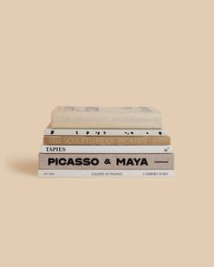 three books stacked on top of each other in front of a beige background with the words picaso and mayoa