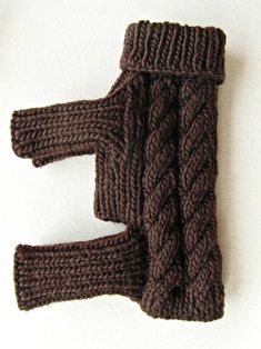 a brown knitted object on a white surface