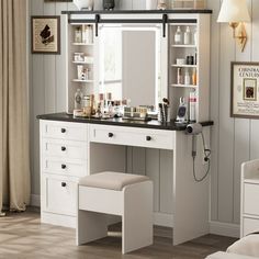 a white vanity with black counter top and drawers in a bedroom next to a window