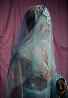 a woman wearing a veil and holding a cell phone