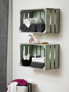 two wooden crates with towels on them are hanging from the wall next to a towel rack