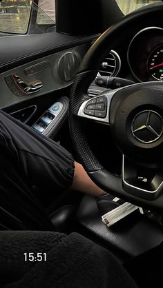 the interior of a car with steering wheel and dashboard