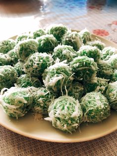 a plate filled with green and white desserts