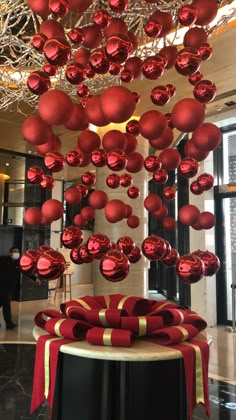 red ornaments hanging from the ceiling in a lobby