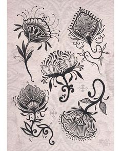 some black and white tattoos on a piece of paper with flowers in the middle, one is