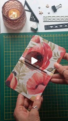 someone is making a flower card holder out of fabric