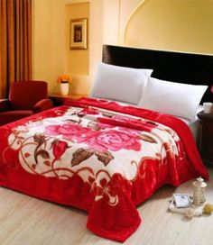 a bed covered in a red and white bedspread