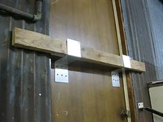 a wooden door with some metal brackets on it