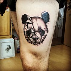 a man's leg with a bear and geometric tattoo design on the side of his thigh