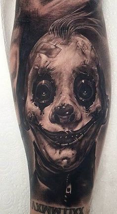 a man's leg with an image of a creepy clown on it and the words,