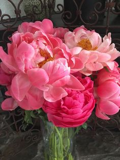 a vase filled with pink flowers on top of a table