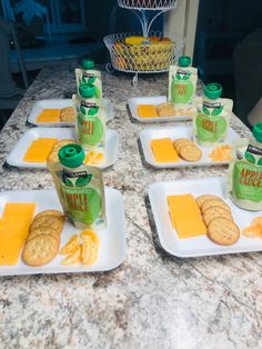 crackers and cheese are arranged on white plates