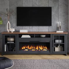 an entertainment center with a fireplace in the middle and a flat screen tv above it