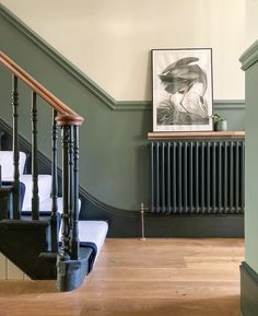 the stairs in this house are painted green and have black railings on each side