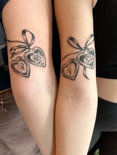 two women with matching tattoos on their arms