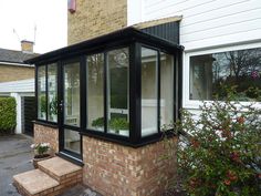 a brick building with glass windows and steps leading up to it