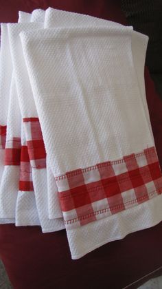 four red and white checkered towels on a table