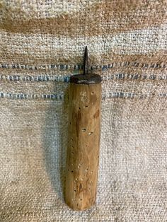 a small wooden object is hanging on the wall next to a carpeted area with blue and white stripes