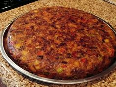 a large pizza sitting on top of a metal pan