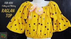 a mannequin wearing a yellow top with black polka dots and pink flowers on it