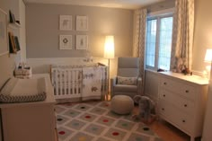 a baby's room is decorated in gray and white