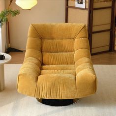 a yellow recliner chair sitting on top of a white rug