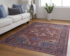 a living room with a couch and rug on the floor