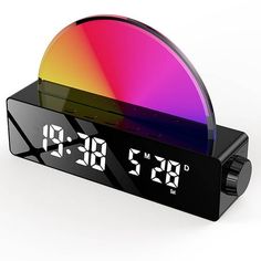 an alarm clock with multicolored display on white background