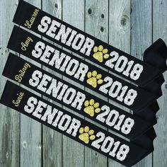 three black and yellow ribbons with the words senior, 2013, and 2018 on them